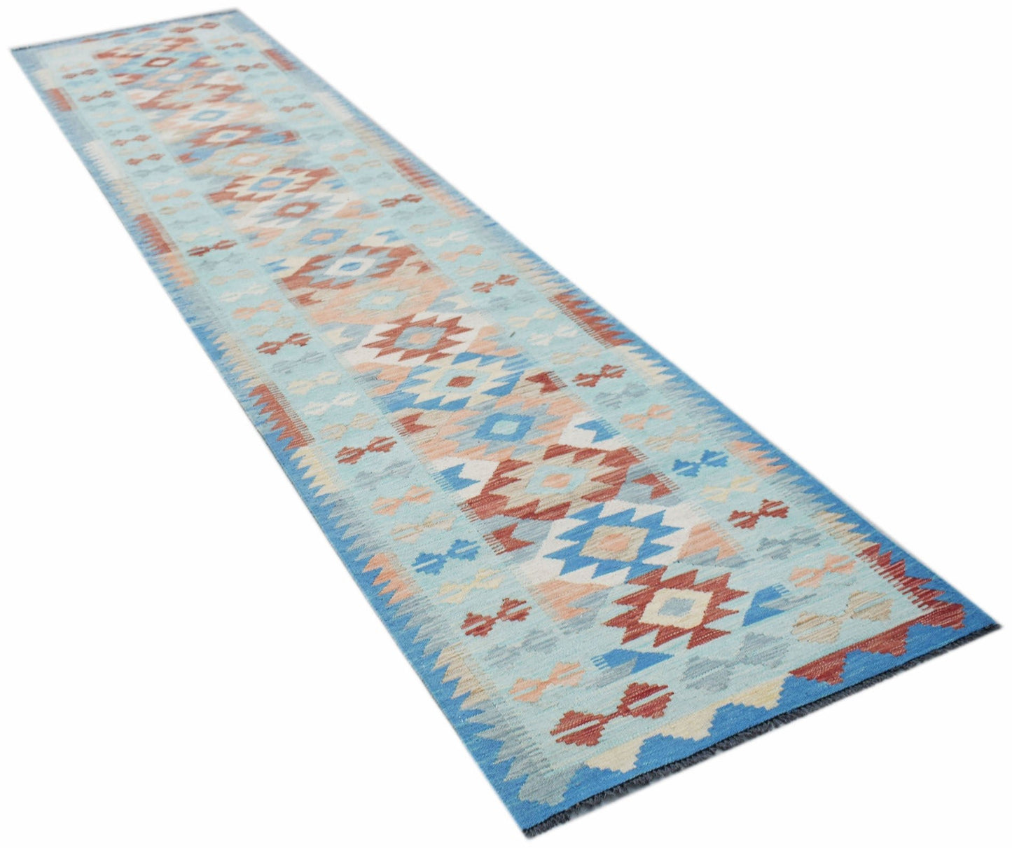 A handmade Afghan Maimana wool runner rug featuring a geometric pattern in blue and red tones.