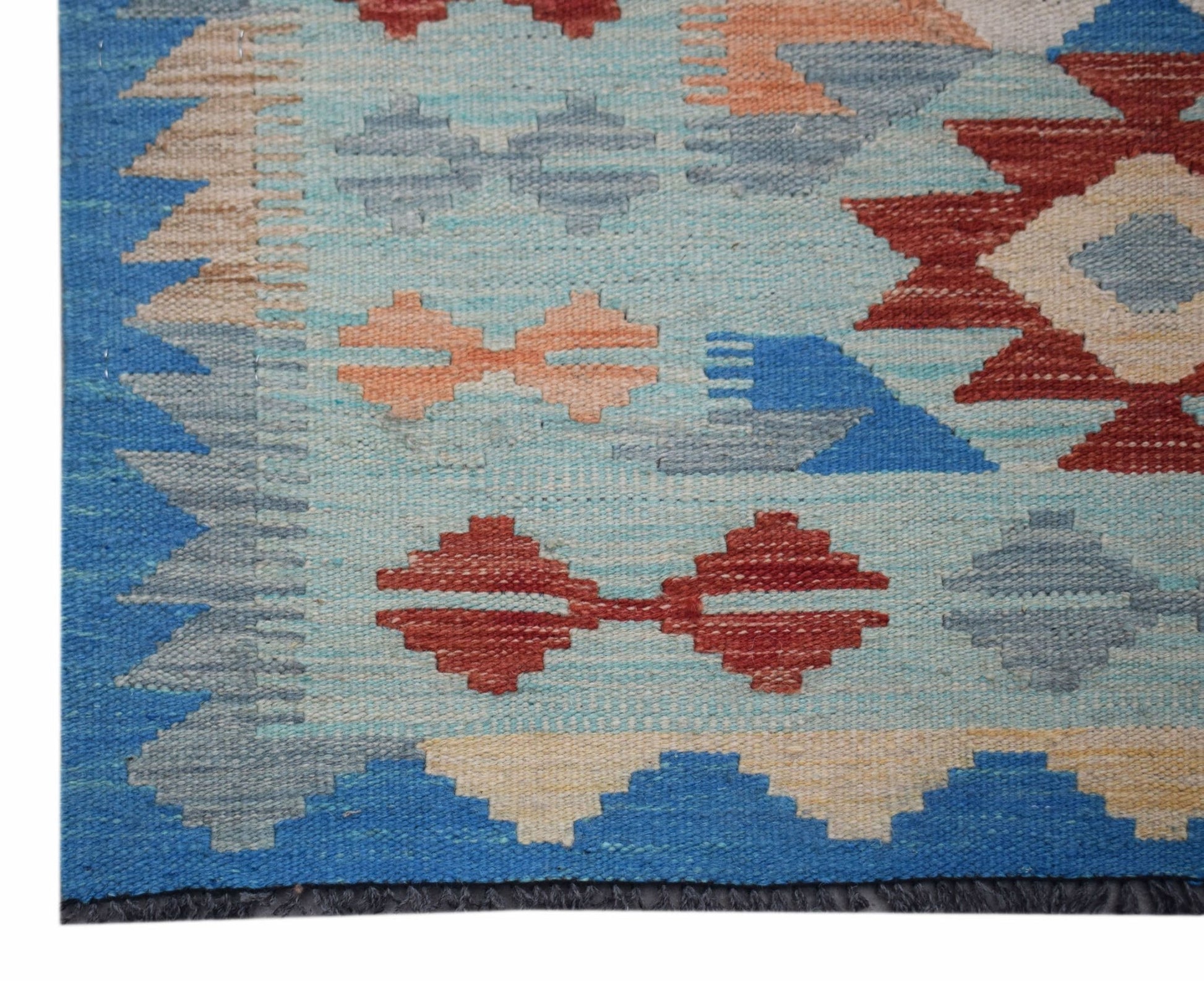 Handwoven Afghan Maimana wool runner featuring geometric patterns in blue, red, and beige.
