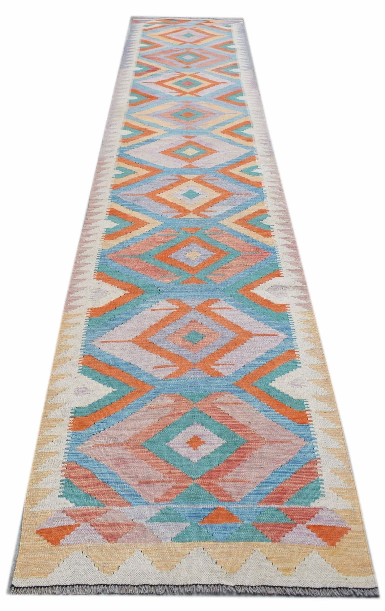 A handmade Afghan Maimana wool runner featuring a colorful geometric diamond pattern.