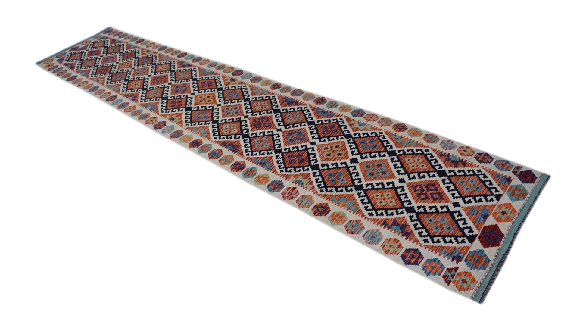 A handmade Afghan Maimana wool runner rug featuring a colorful geometric diamond pattern.