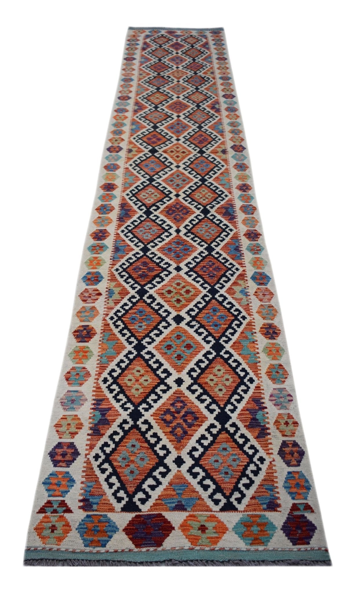 A handmade Afghan Maimana wool runner featuring a colorful geometric diamond pattern.