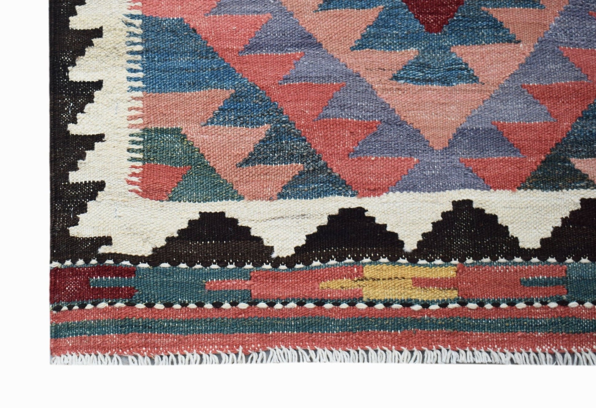 A handmade Afghan Maimana kilim runner featuring geometric patterns in red, blue, and yellow.