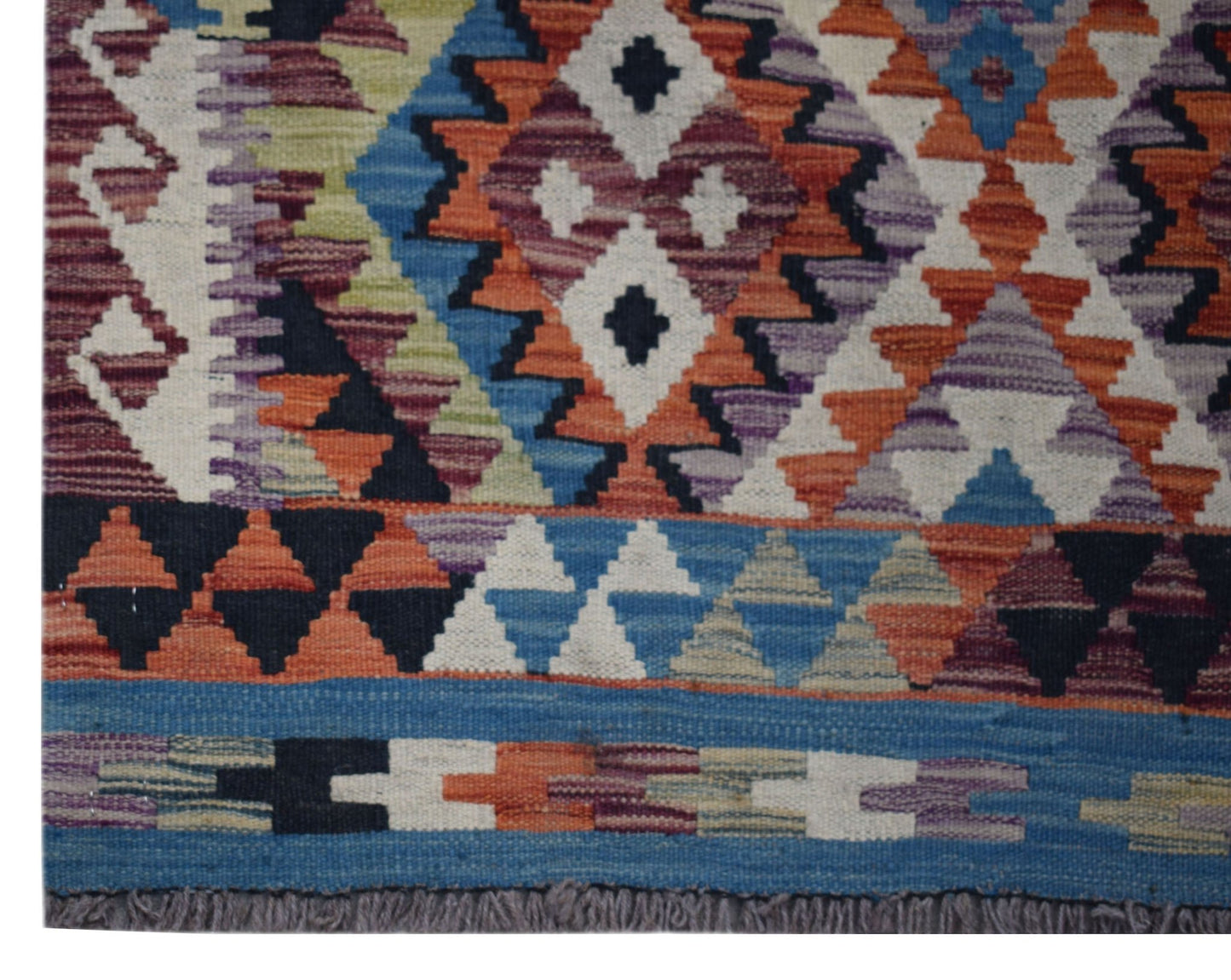 Handwoven Afghan Maimana wool kilim runner featuring a colorful geometric pattern and fringe ends.