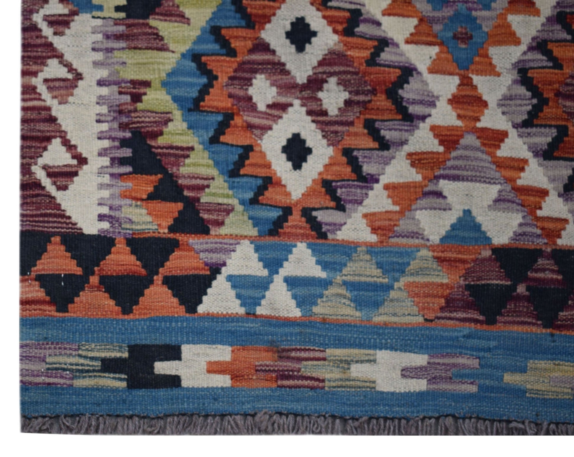 Handwoven Afghan Maimana wool kilim runner featuring a colorful geometric pattern and fringe ends.