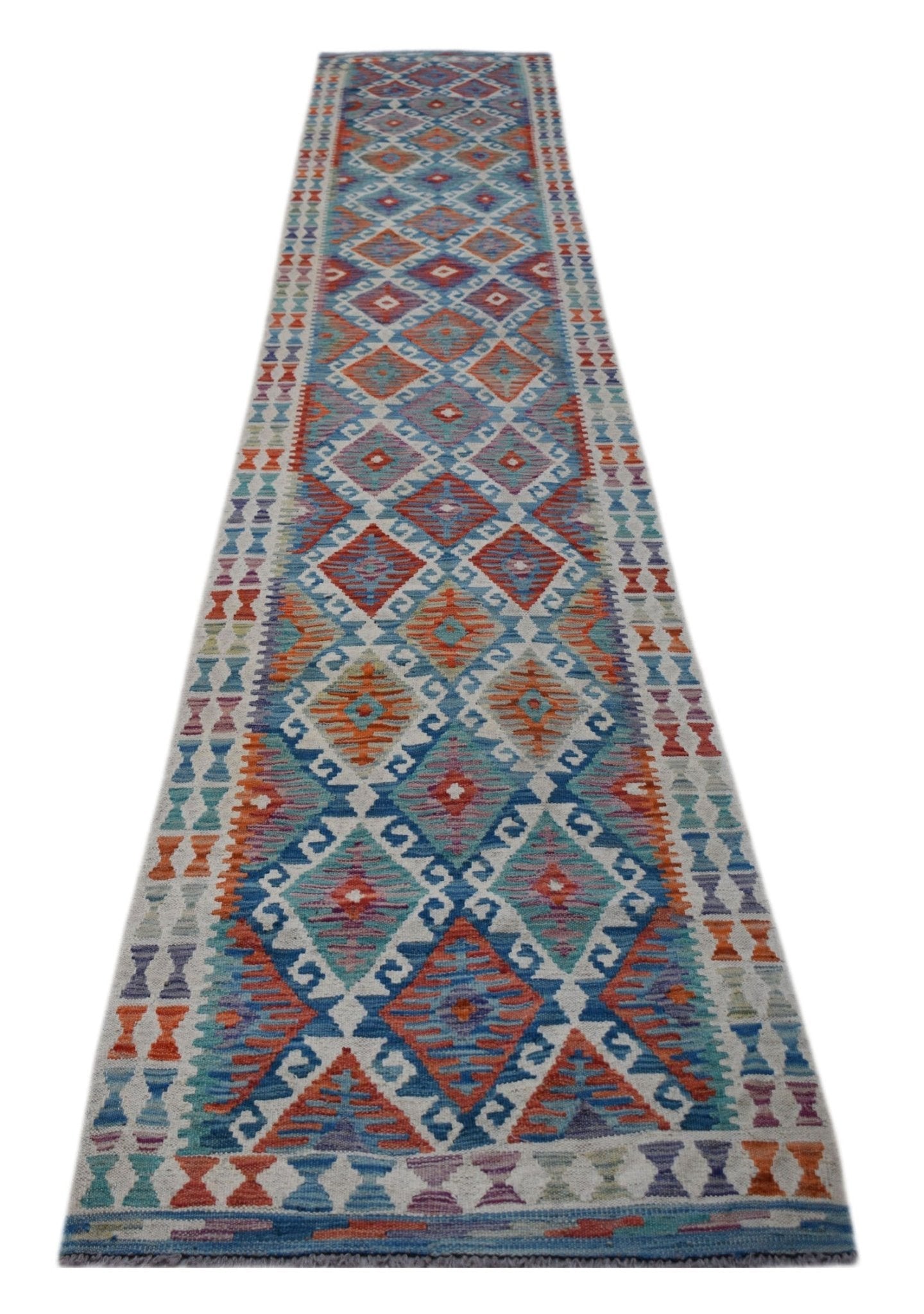 A long, handmade Afghan Maimana Kilim runner featuring a colorful geometric diamond pattern.