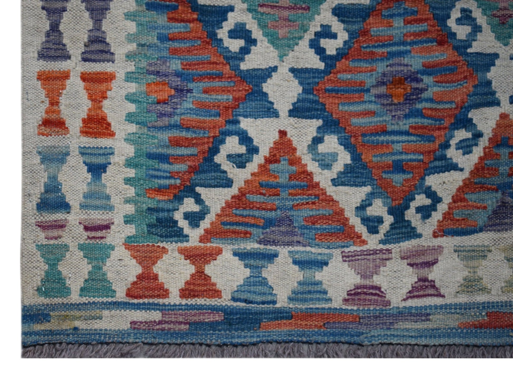 Handwoven Afghan Maimana wool runner featuring a geometric pattern in blue, orange, and purple.