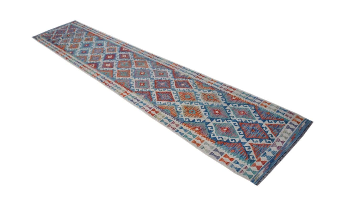 A long, handmade Afghan Maimana kilim runner featuring a geometric pattern in blue, red, and orange.