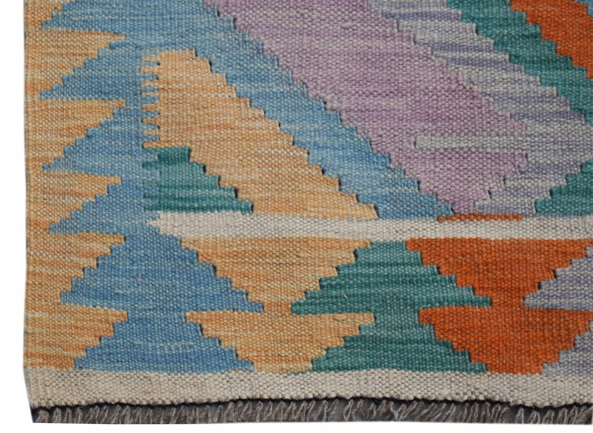 A handmade Afghan Maimana Kilim runner featuring a geometric pattern in vibrant, multicolored wool.