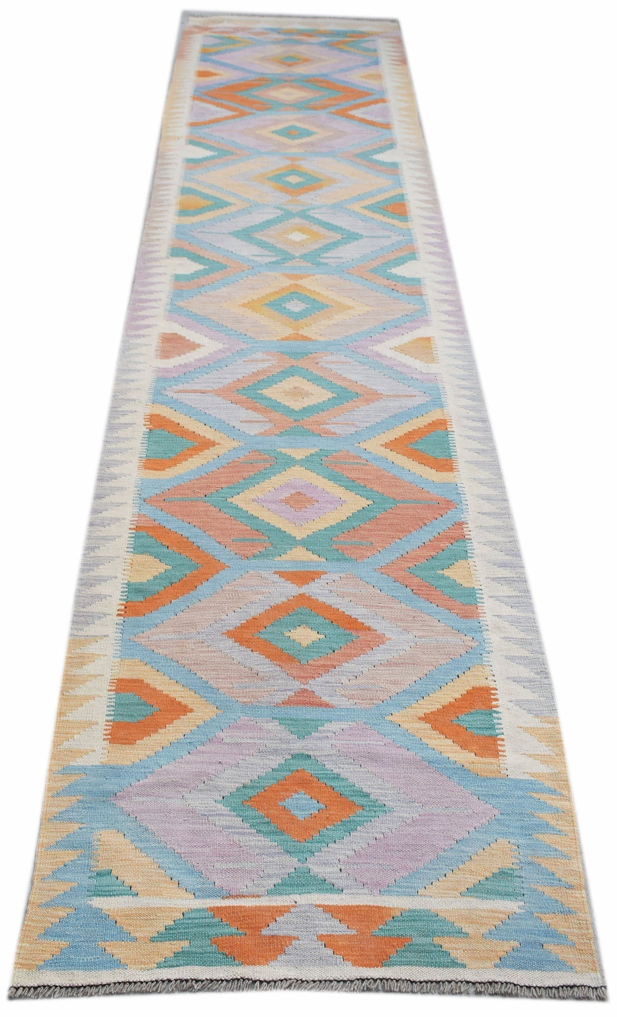 A handmade Afghan Maimana wool runner rug featuring a colorful geometric diamond pattern.