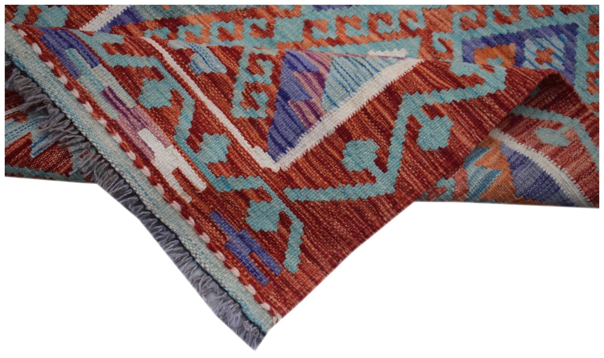 A handmade Afghan Maimana wool kilim runner featuring geometric patterns in red, blue, and orange.
