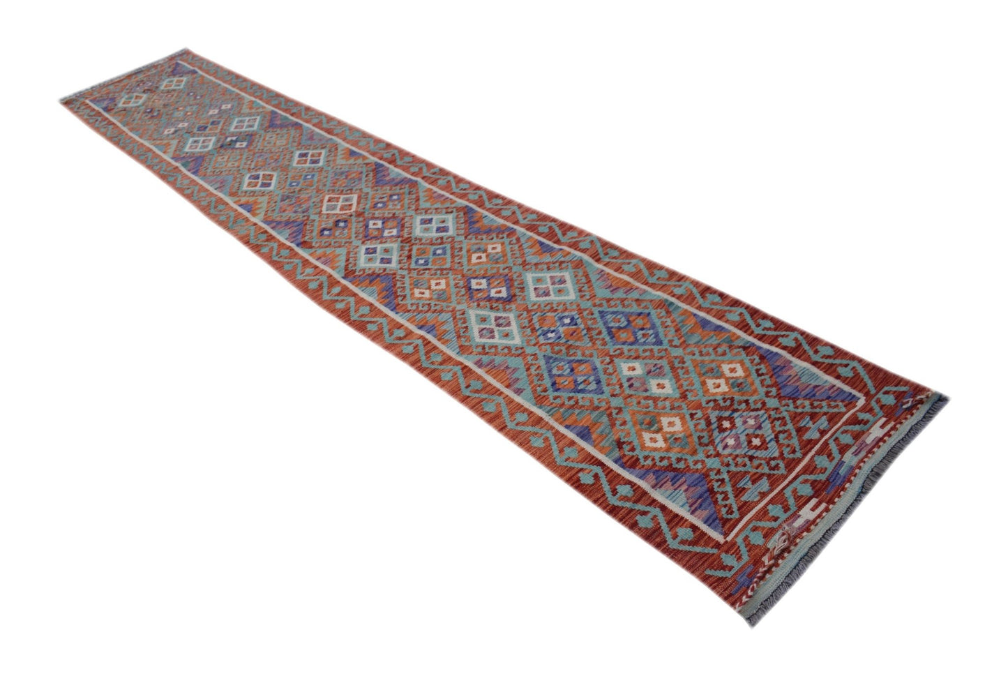 A handmade Afghan Maimana kilim runner featuring a geometric pattern in red, blue, and cream tones.