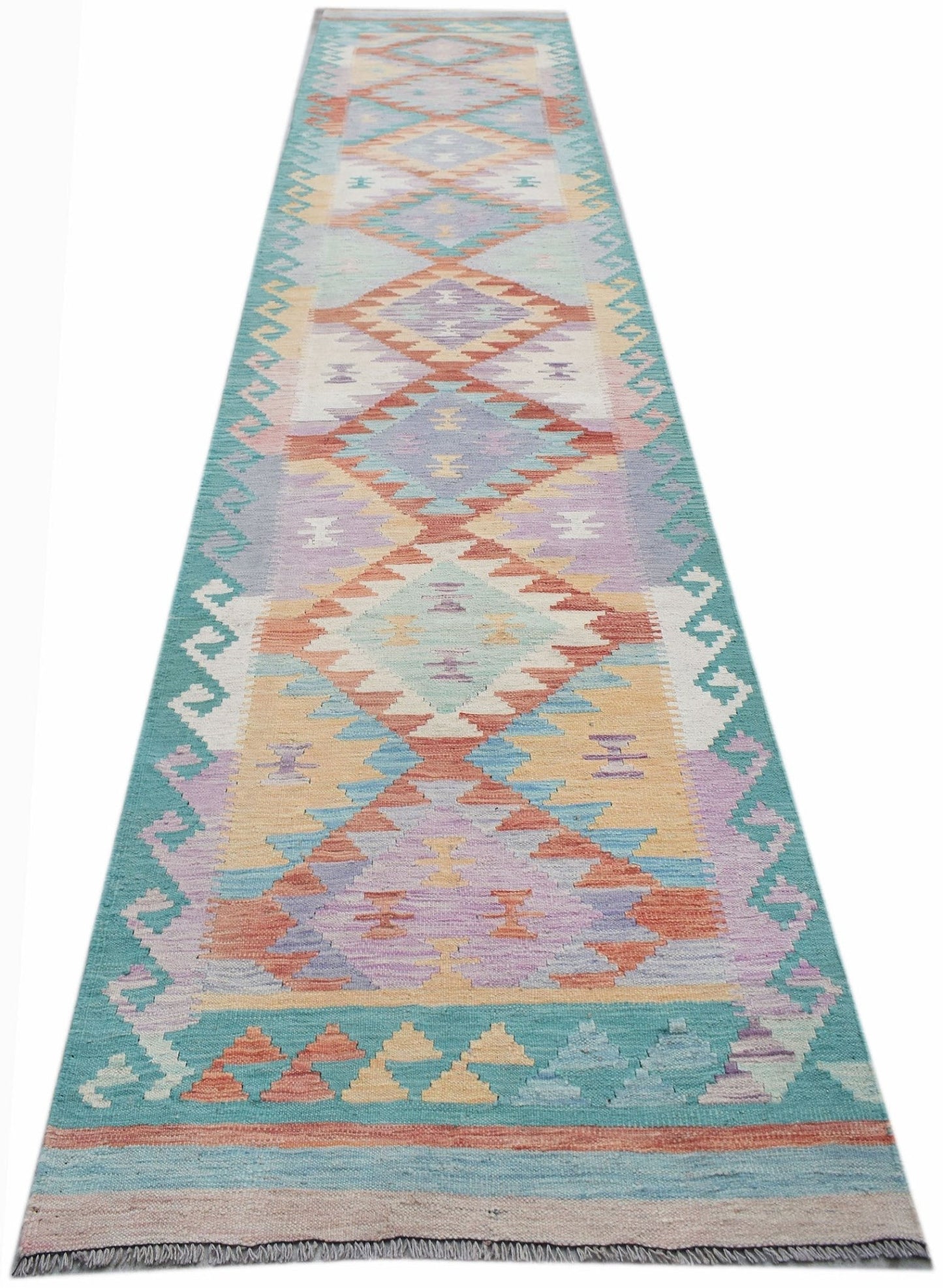 A handmade Afghan Maimana wool runner rug featuring a colorful geometric diamond pattern.