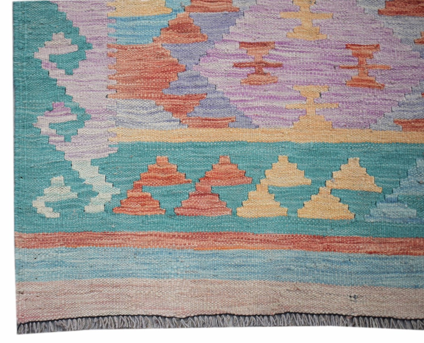 Handwoven Afghan Maimana kilim runner featuring a geometric pattern in teal, purple, and orange.