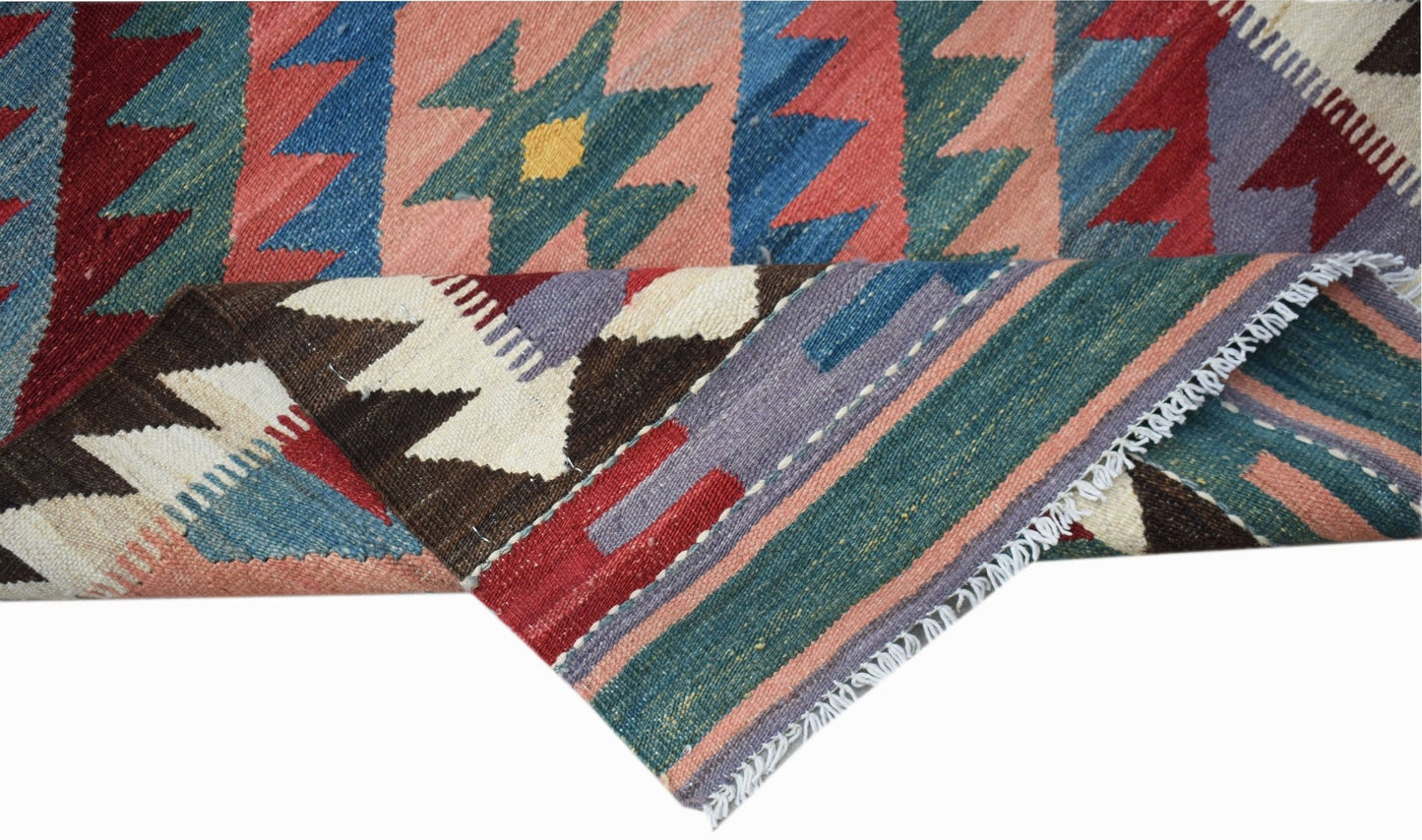 A handmade Afghan Maimana wool kilim runner featuring geometric patterns in vibrant colors.