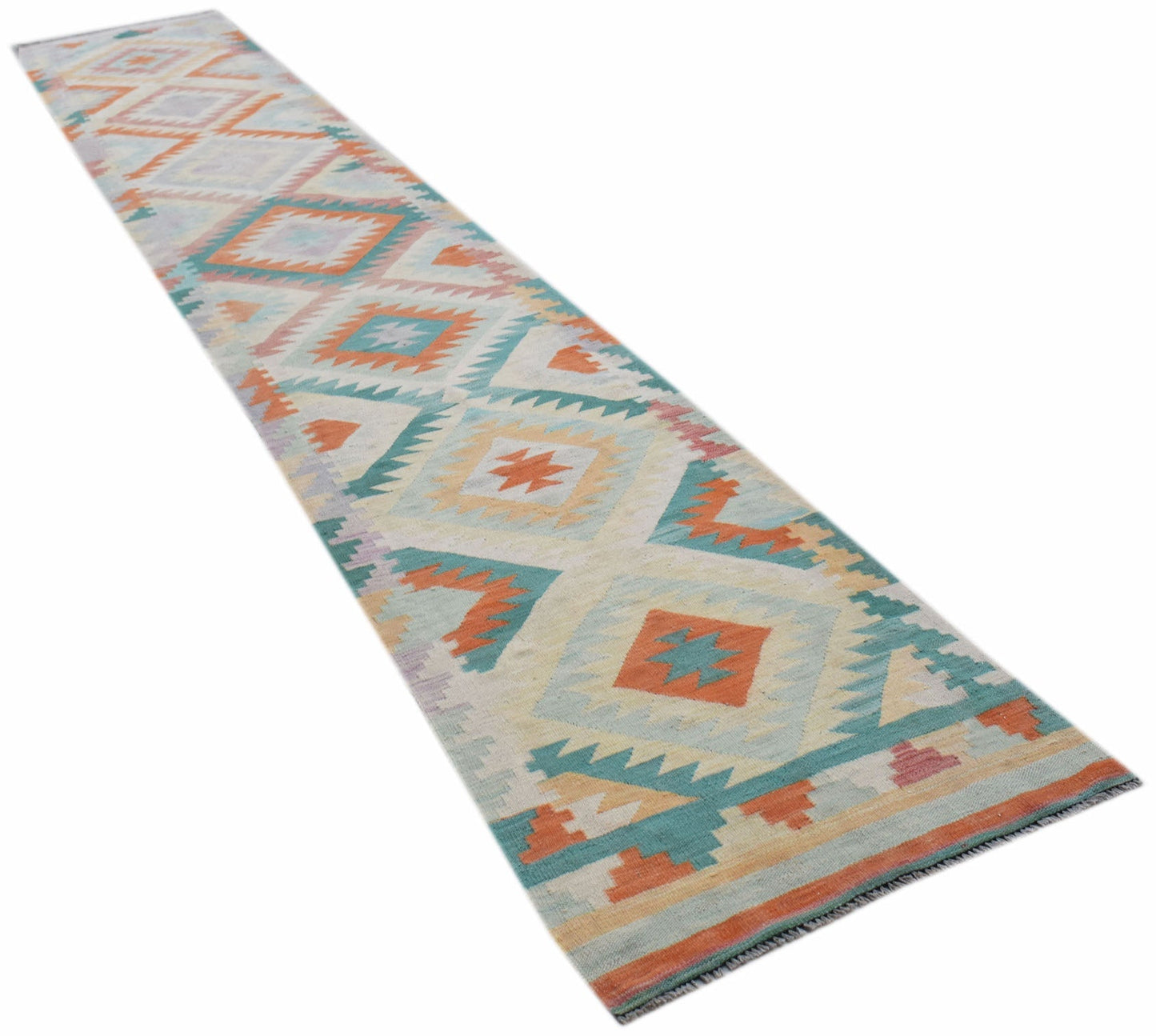 A handmade Afghan Maimana wool runner rug featuring a geometric diamond pattern in muted colors.