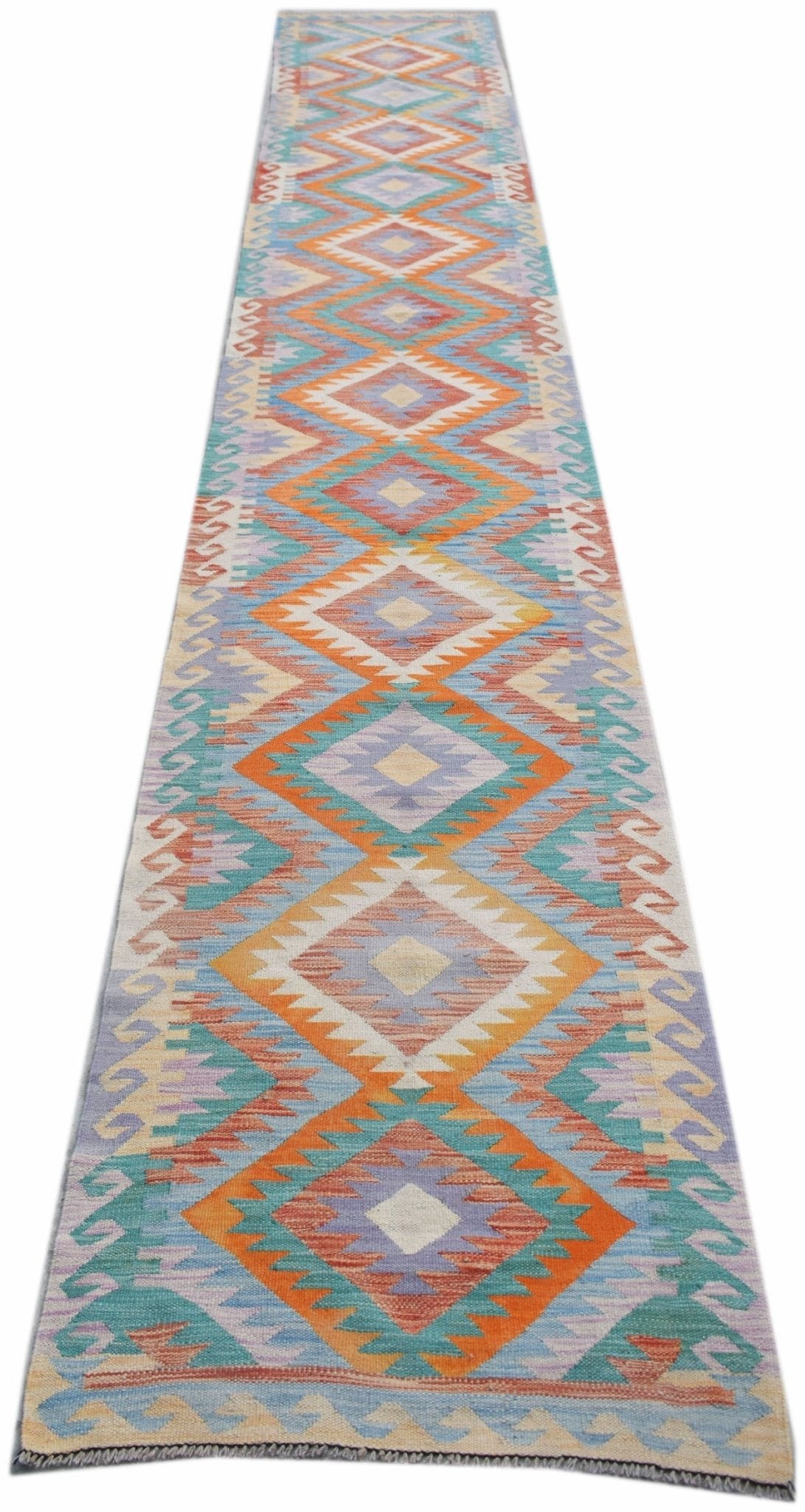 A long, handmade Afghan Maimana kilim runner featuring a vibrant geometric diamond pattern.