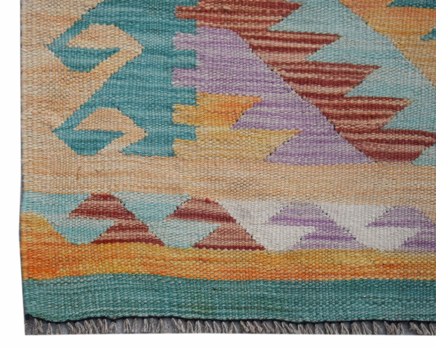 Handwoven Afghan Maimana wool runner featuring a geometric pattern in vibrant multicolored tones.