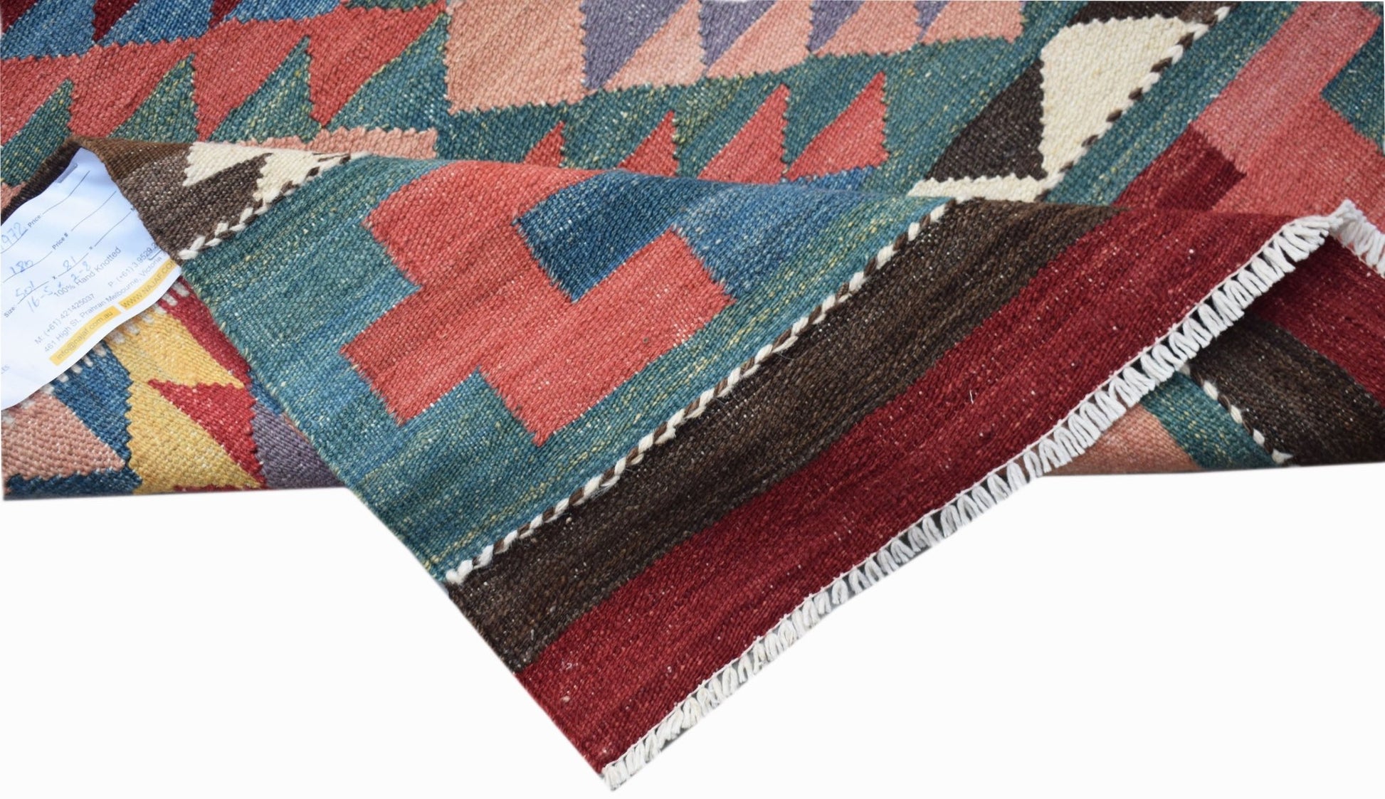 A handwoven Afghan Maimana kilim runner featuring geometric patterns in red, blue, and brown.