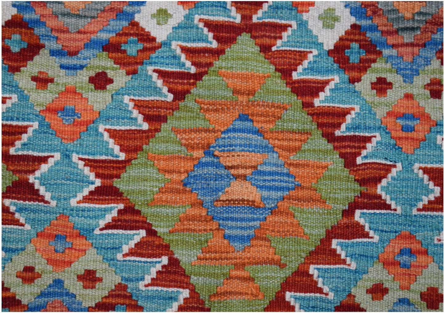 Handwoven Afghan Maimana kilim rug featuring a vibrant geometric diamond pattern in wool.
