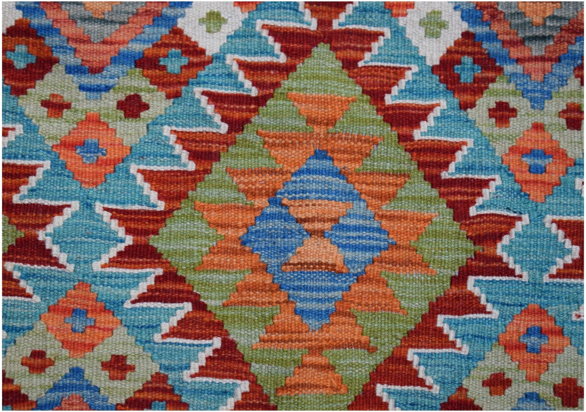 Handwoven Afghan Maimana kilim rug featuring a vibrant geometric diamond pattern in wool.