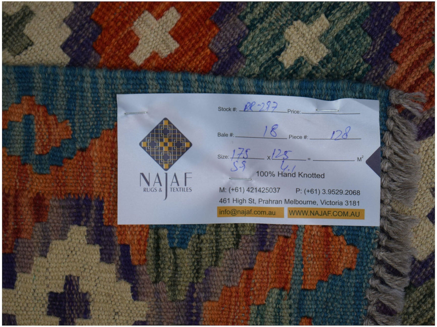 A handwoven Afghan Maimana kilim rug featuring a colorful geometric pattern and flatweave texture.