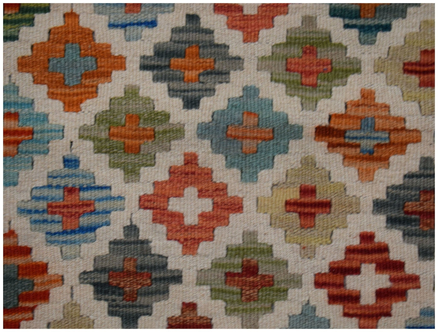 Handwoven Afghan Maimana kilim rug featuring a repeating geometric diamond pattern in multi-colors.