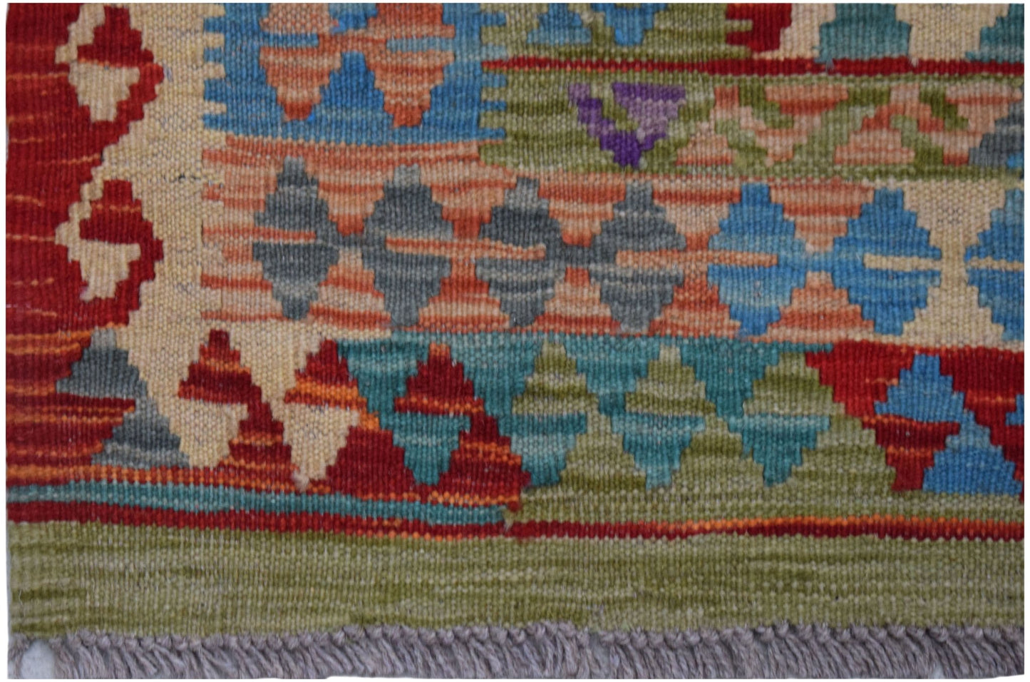 Handwoven Afghan Maimana kilim rug featuring a geometric pattern in vibrant multicolored wool.