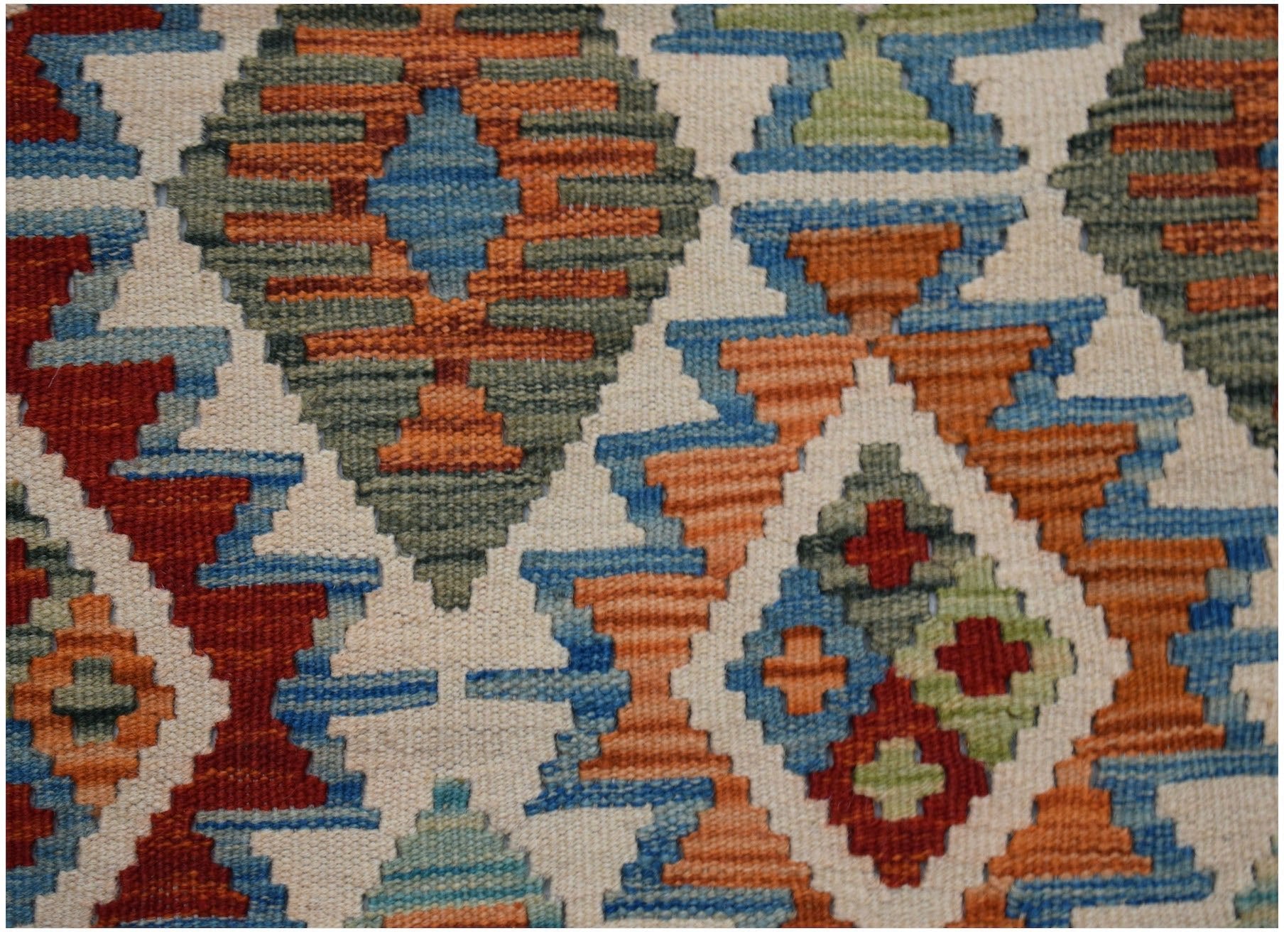 Handwoven Afghan Maimana kilim rug featuring a geometric diamond pattern in vibrant wool colors.