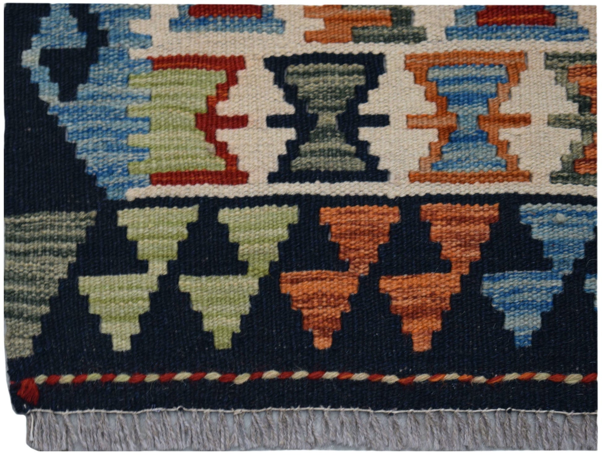 A close-up of a handmade Afghan Maimana kilim featuring geometric patterns in vibrant colors.