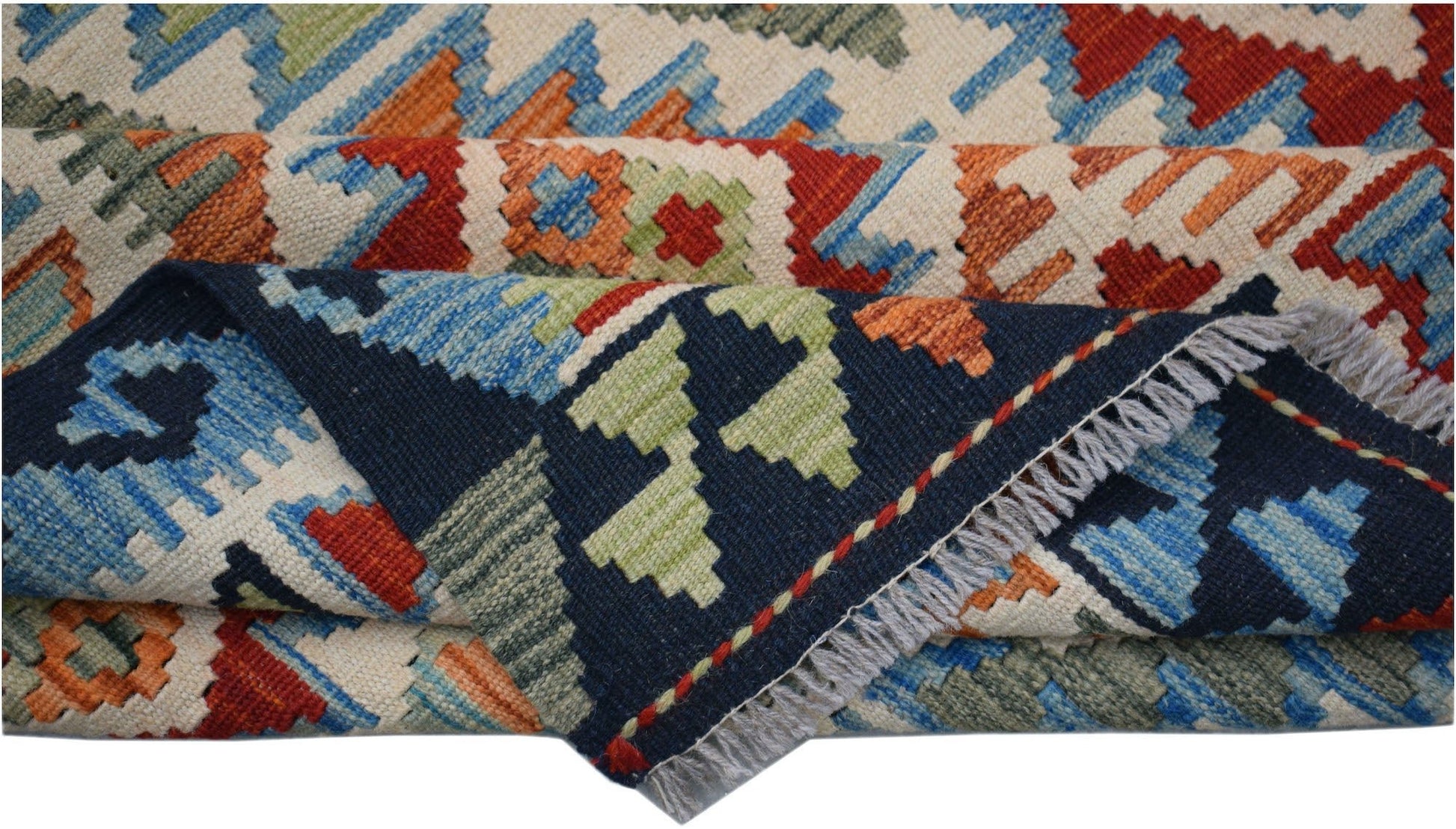 A handmade Afghan Maimana kilim rug featuring a geometric pattern in blue, red, and green wool.