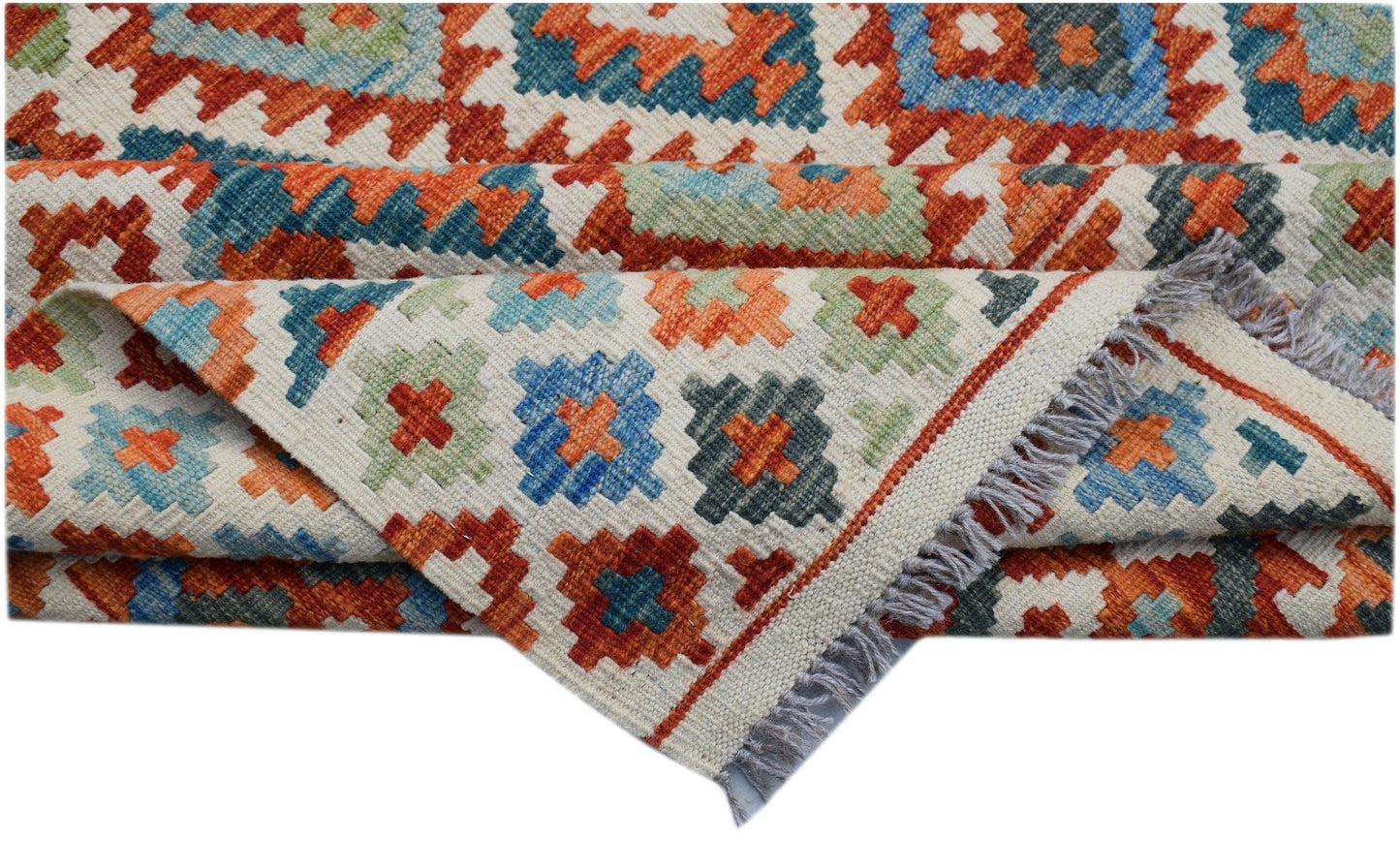 Handwoven Afghan Maimana kilim rug featuring a geometric pattern in orange, blue, and green wool.
