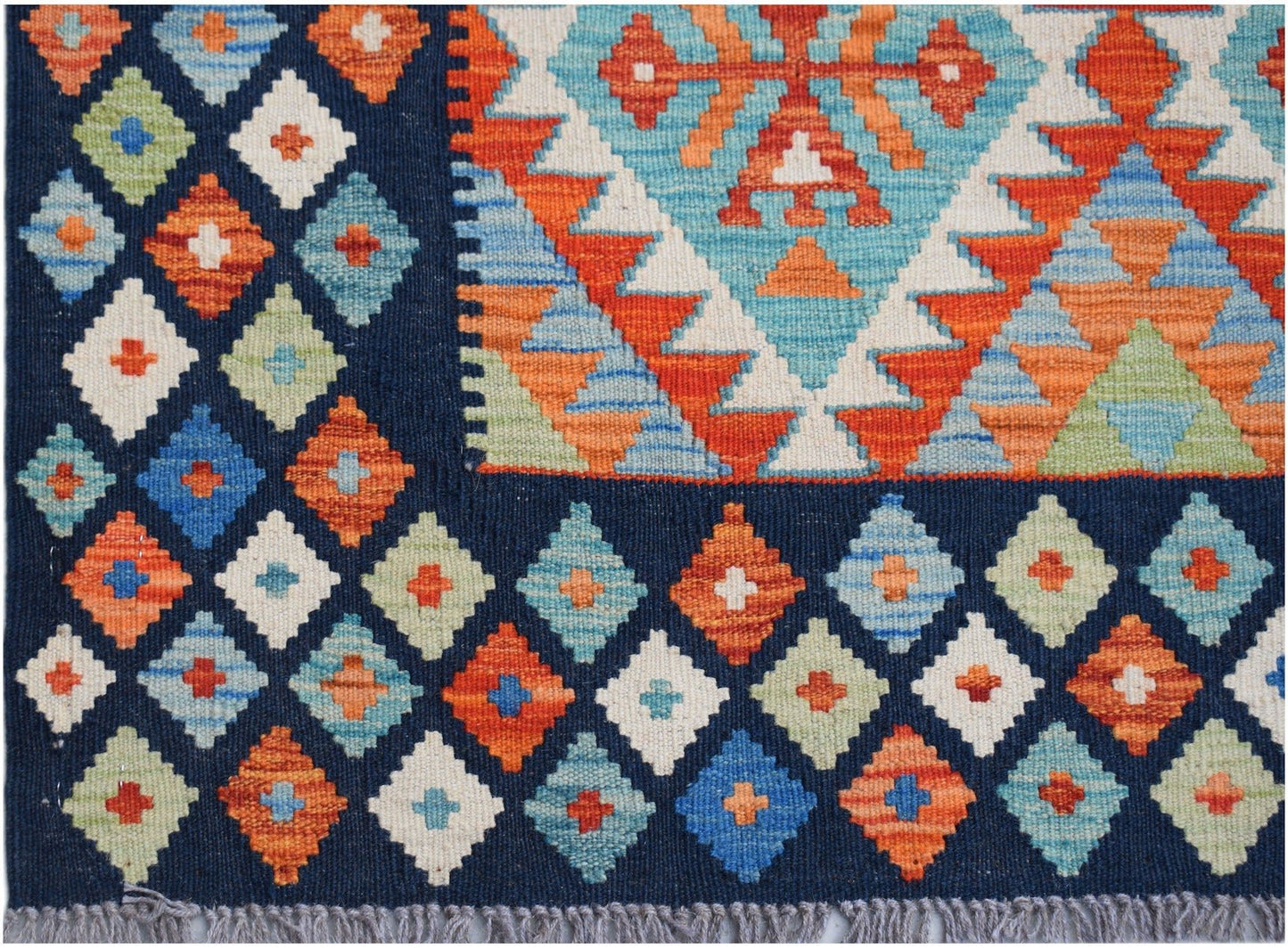 Handwoven Afghan Maimana kilim rug featuring a geometric diamond pattern in vibrant colors.