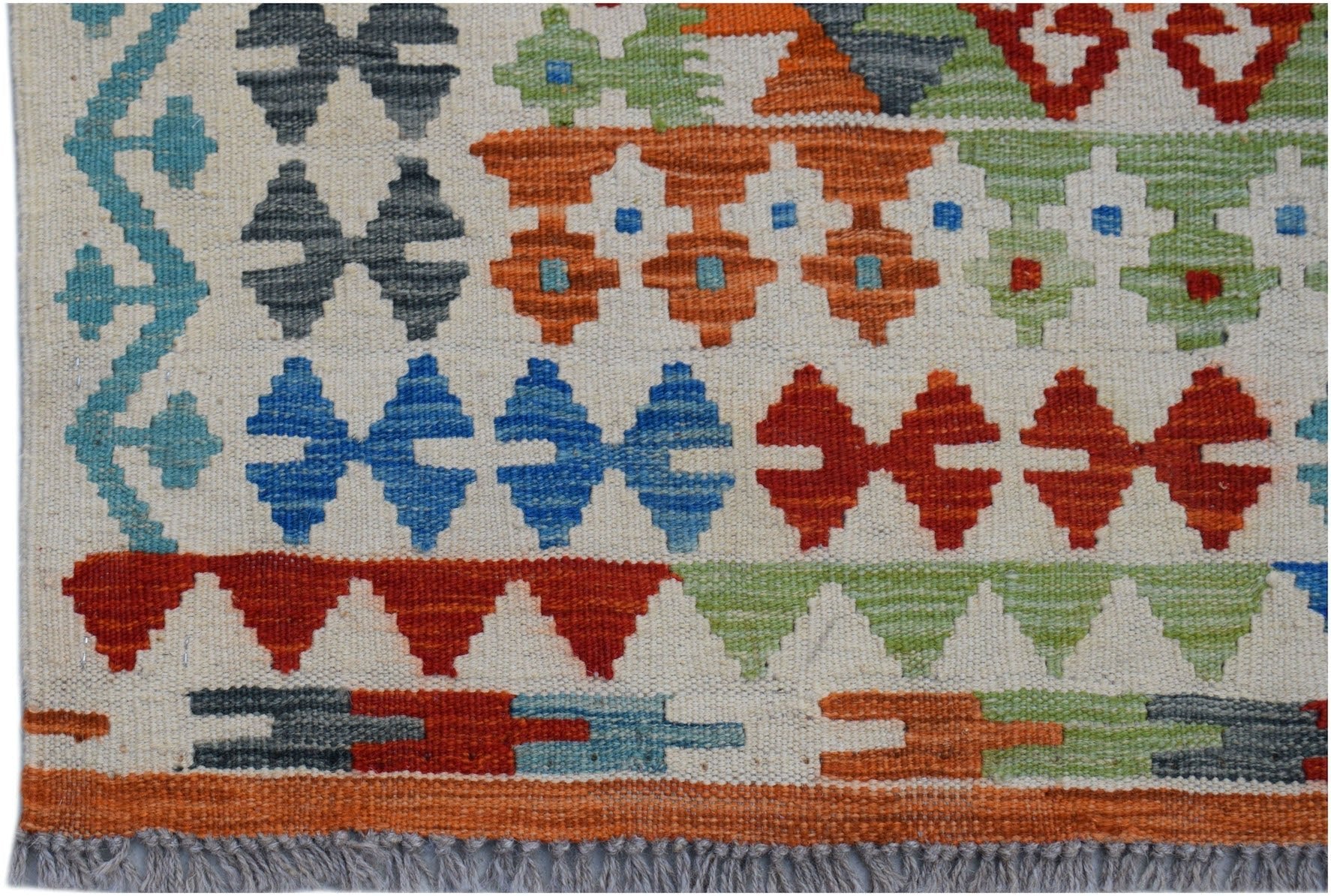 Handwoven Afghan Maimana kilim rug featuring geometric patterns in vibrant multi-colored wool.