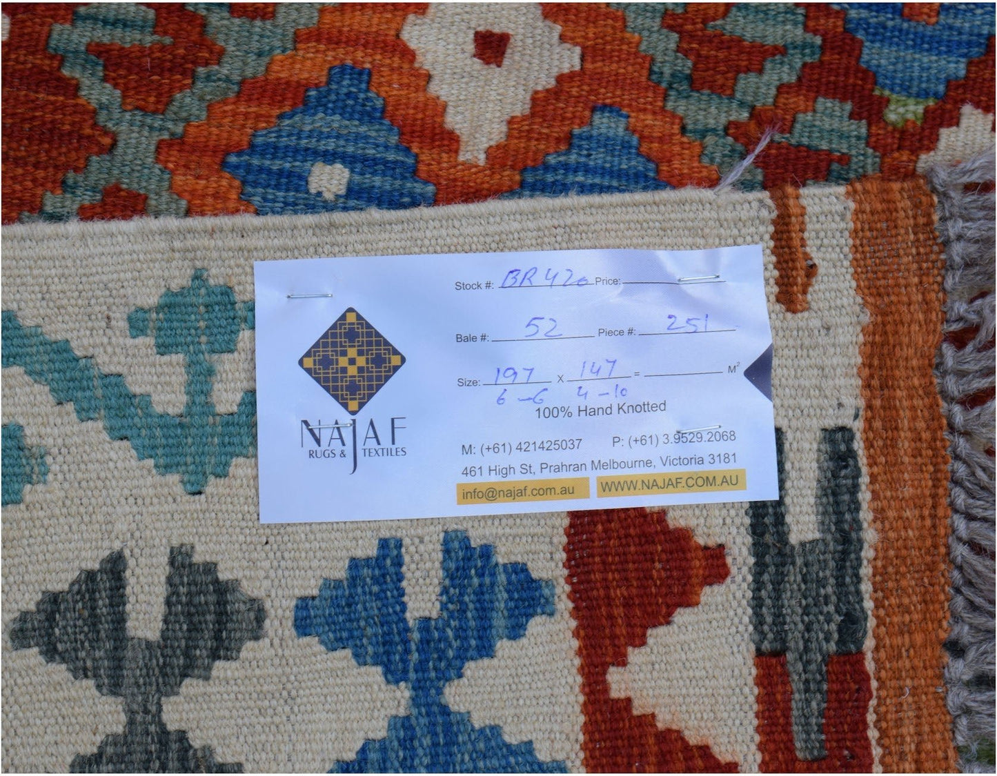 A handmade Afghan Maimana kilim featuring a geometric pattern in blue, orange, and cream tones.