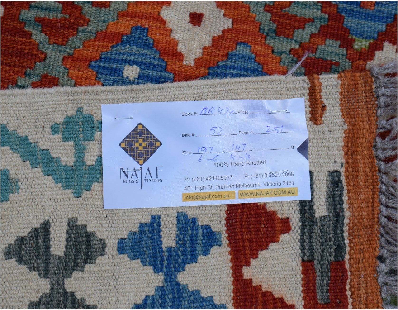 A handmade Afghan Maimana kilim featuring a geometric pattern in blue, orange, and cream tones.