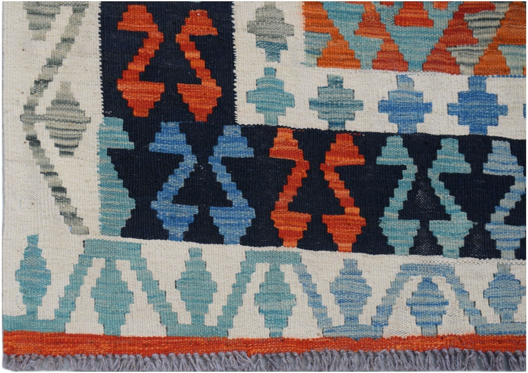 Handwoven Afghan Maimana kilim rug featuring geometric patterns in blue, orange, and cream.