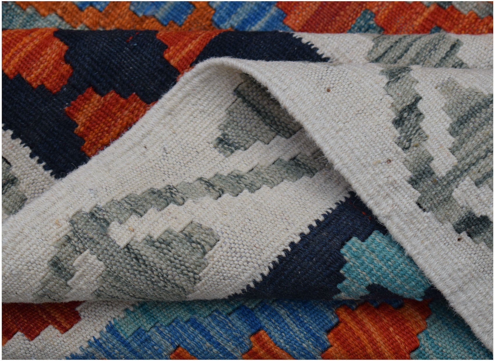 A handwoven Afghan Maimana kilim rug featuring a geometric pattern in orange, blue, and cream.
