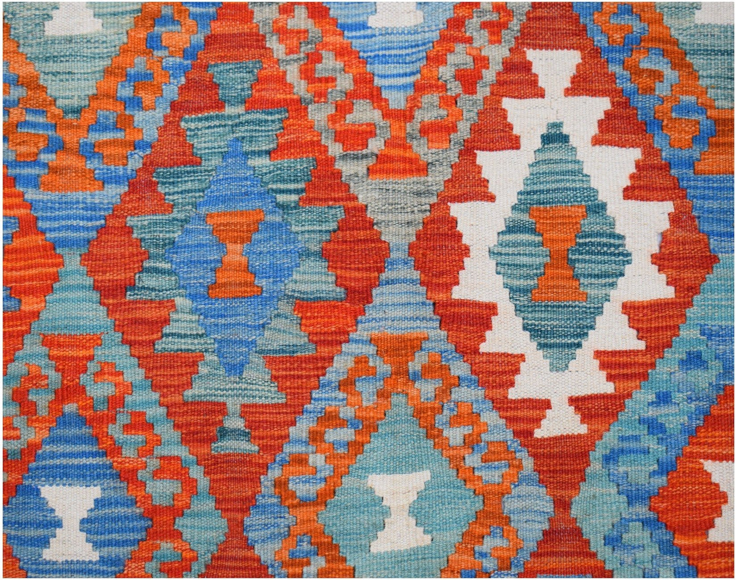 Handwoven Afghan Maimana kilim rug featuring a vibrant geometric diamond pattern in wool.