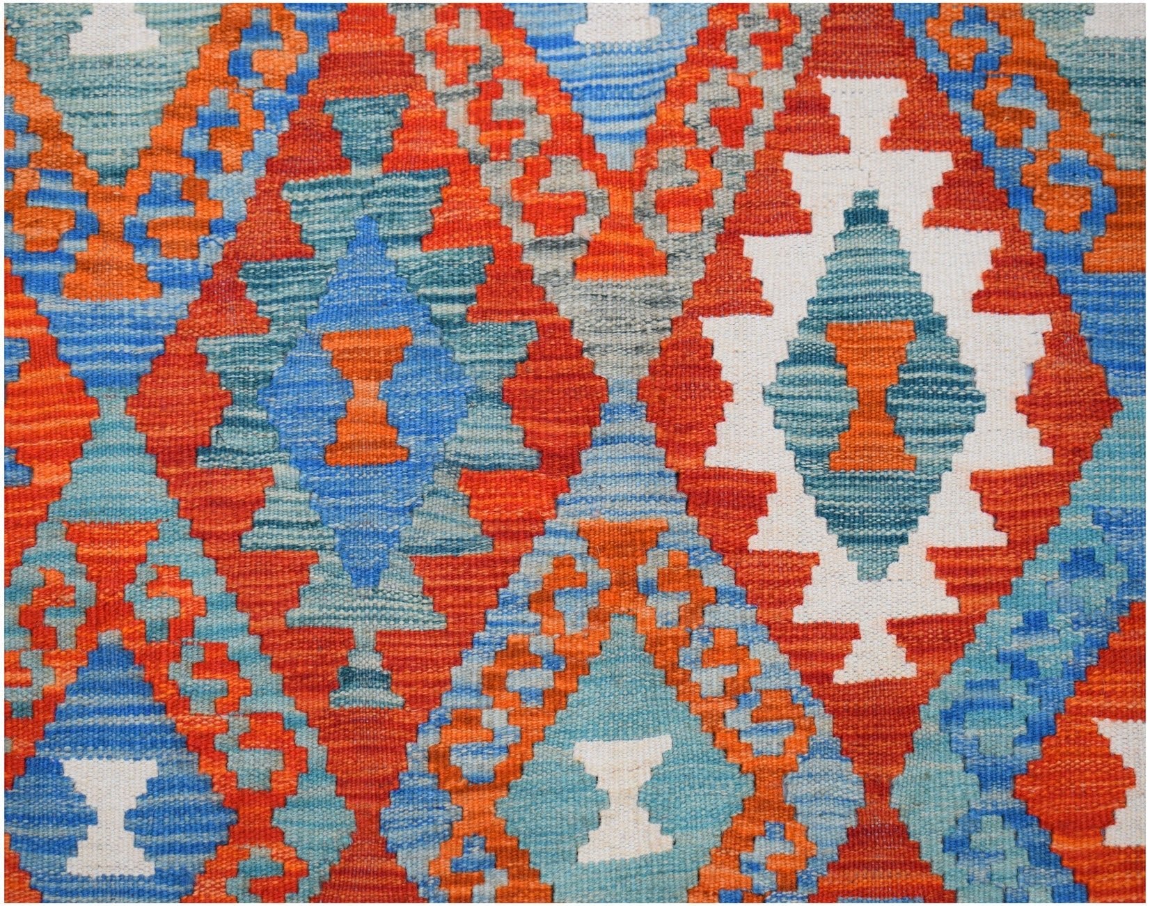 Handwoven Afghan Maimana kilim rug featuring a vibrant geometric diamond pattern in wool.