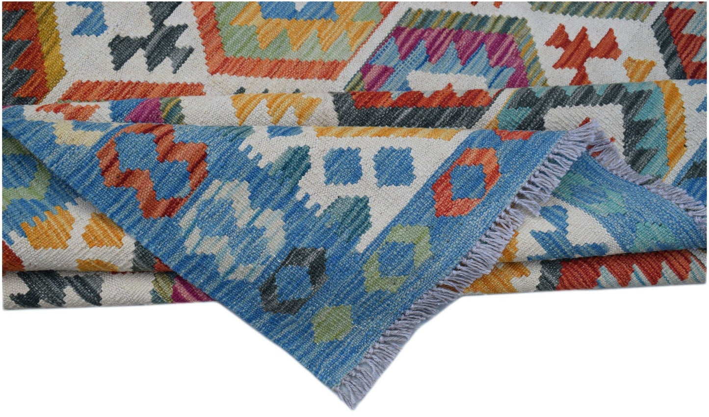 Handwoven Afghan Maimana kilim rug featuring a colorful geometric pattern and fringed edges.