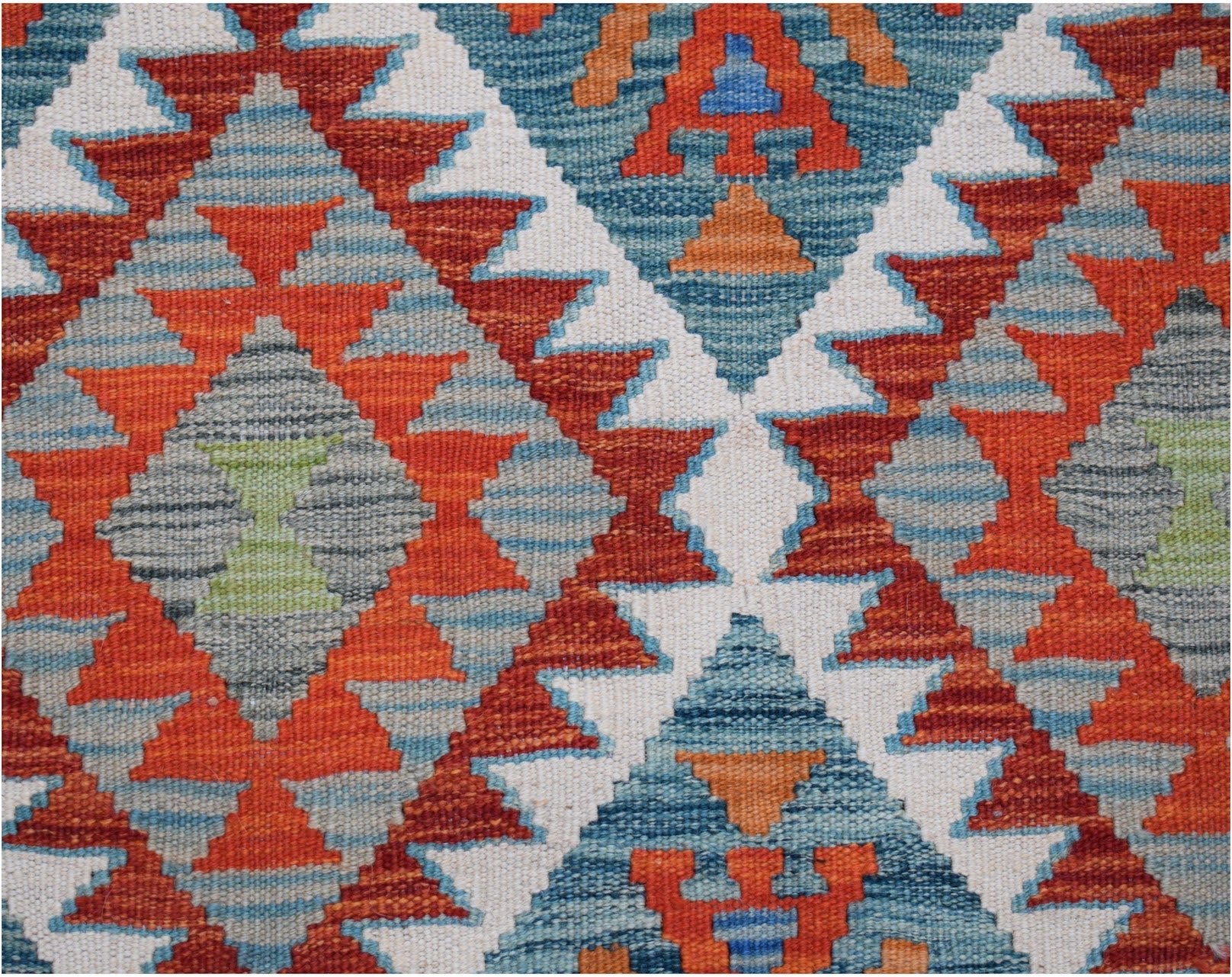 Handwoven Afghan Maimana kilim rug featuring a geometric diamond pattern in orange, blue, and grey.