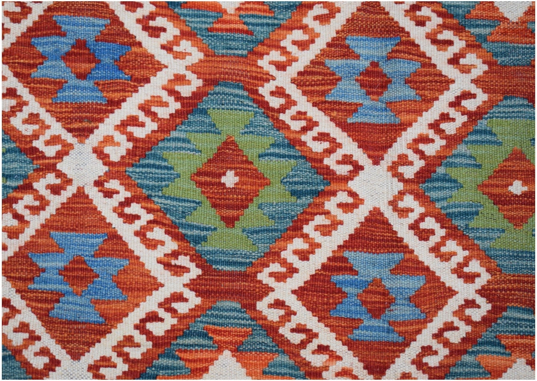 Handwoven Afghan Maimana kilim featuring a geometric diamond pattern in orange, blue, and green.