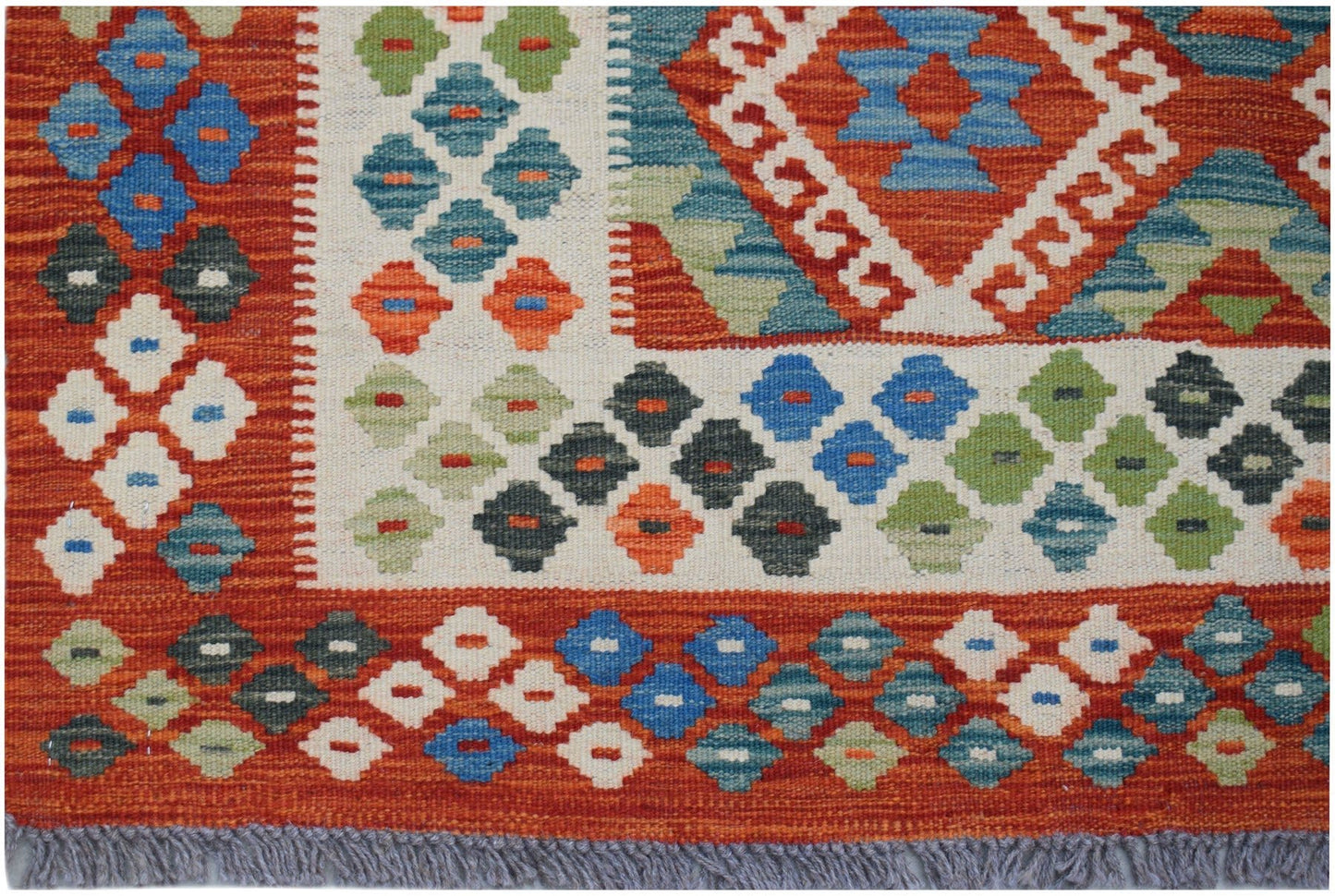 Handwoven Afghan Maimana kilim rug featuring a geometric diamond pattern in vibrant colors.