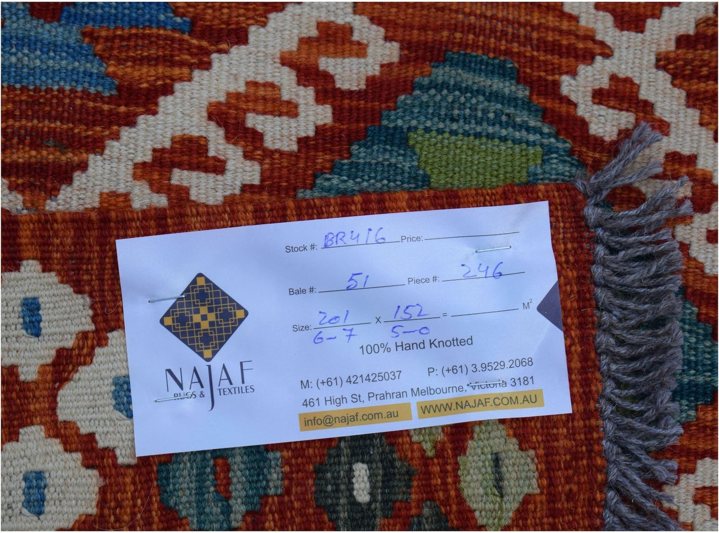 A handwoven Afghan Maimana kilim featuring a geometric pattern in shades of orange, blue, and green.