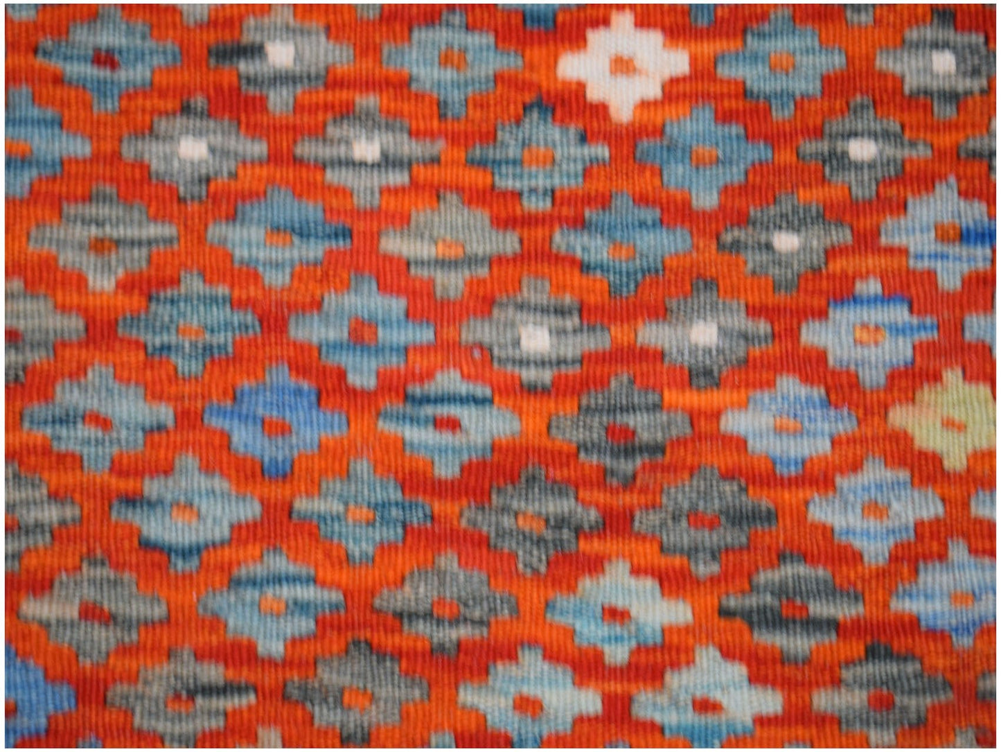 Handwoven Afghan Maimana kilim featuring a repeating geometric diamond pattern in orange and blue.