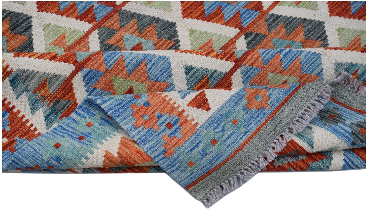 Handwoven Afghan Maimana kilim rug featuring a geometric pattern in blue, orange, and green wool.