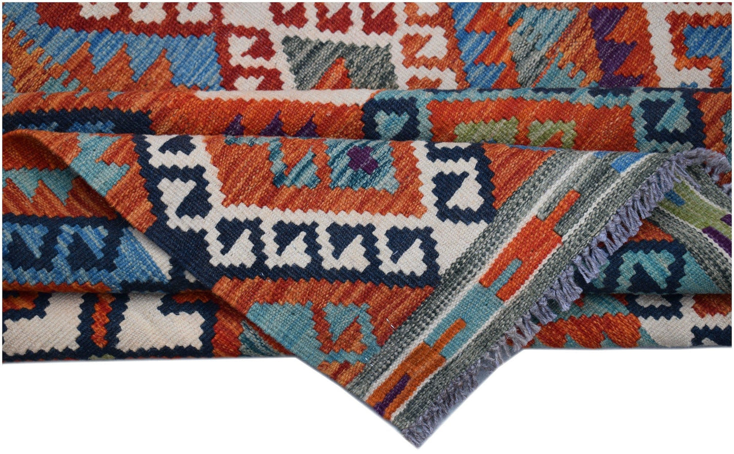 A handwoven Afghan Maimana kilim rug featuring vibrant geometric patterns in wool.