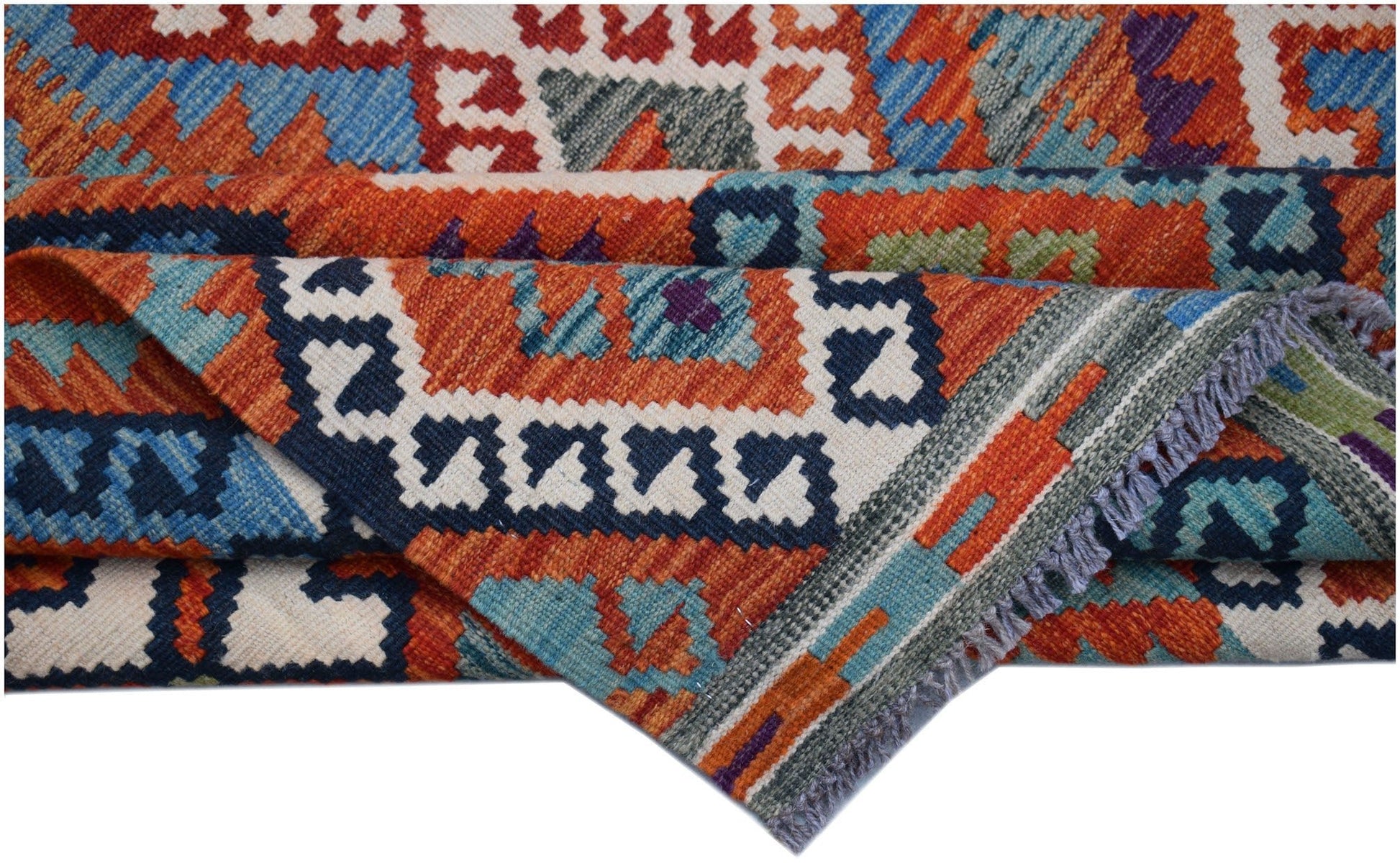 A handwoven Afghan Maimana kilim rug featuring vibrant geometric patterns in wool.