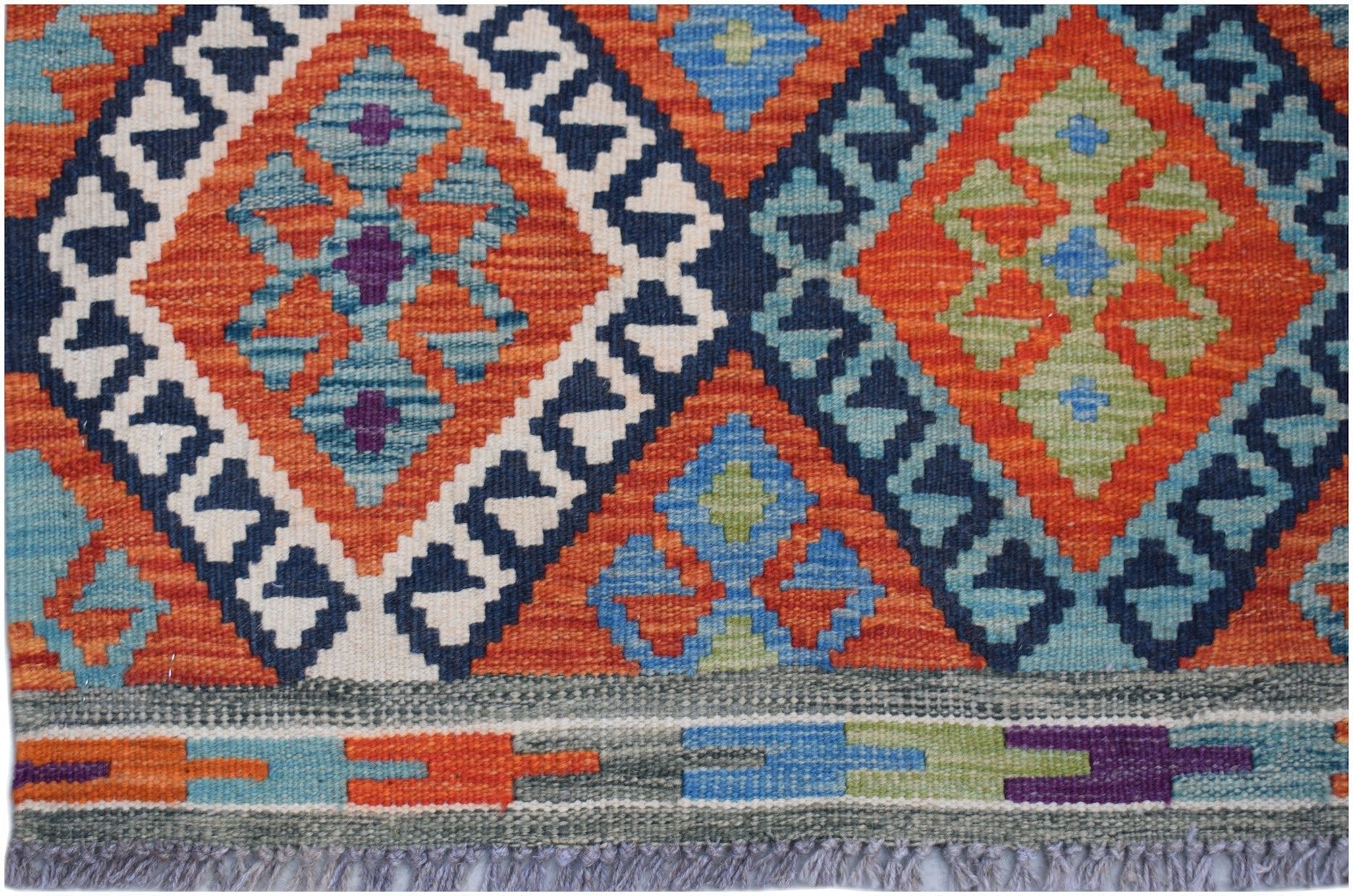 Handwoven Afghan Maimana kilim rug featuring a geometric diamond pattern in vibrant colors.