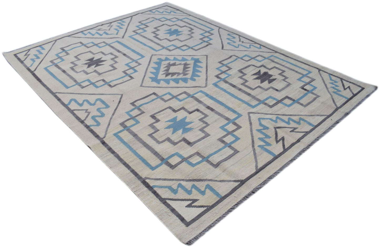 A handmade Afghan Maimana kilim rug featuring a geometric pattern in blue and grey on a cream base.
